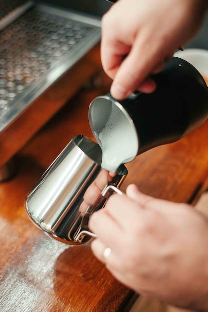 Premium Photo Cropped Hands Pouring Milk In Cup