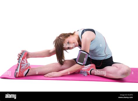 Pretty Brunette Looking At Camera And Stretching Her Leg On Exercise Mat Stock Photo Alamy