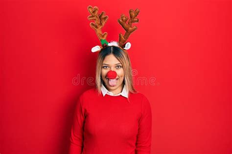 Beautiful Hispanic Woman Wearing Deer Christmas Hat And Red Nose