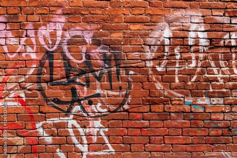 Red Brick Wall With Graffiti In Different Colors Uk