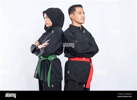 Asian Men And Women Wearing Pencak Silat Uniforms Stand With Crossed