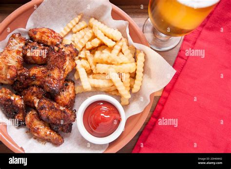 Hot And Spicy Buffalo Style Chicken Wings And Fries In A Basket Stock Photo Alamy