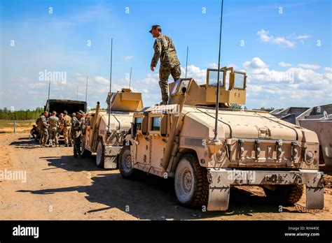 NATO Hummer military vehicles. Soldier on armored Hummer. International ...