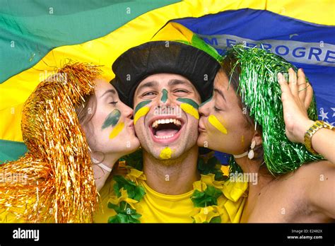 Group Of Happy Brazilian Soccer Fans Celebrating Victory Kissing Each