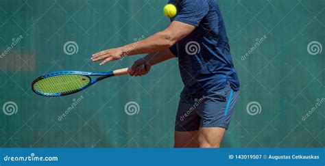 Close Up Photo Of A Man Swinging A Tennis Racquet During A Tennis Match