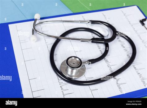 Stethoscope Laying On A Blue Clipboard With A Medical Chart On Top On