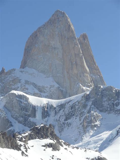 the mountain is covered in snow and there are no clouds