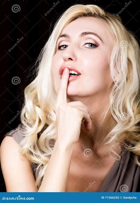 Close Up Of Red Lips Of Seductive Blonde Girl Raising Finger To Her