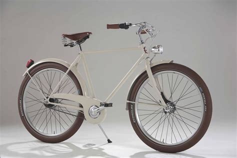 A White Bicycle With Brown Spokes On The Front And Back Wheel Against