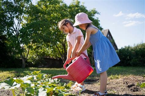 Free Photo | Girl using watering can outdoors in nature