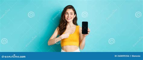 Portrait Of Cute Brunette Woman Pointing Finger At Smartphone Screen