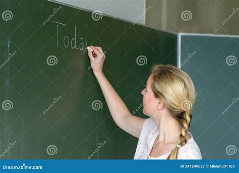 Female Teacher Writing With Chalk On A Chalkboard Stock Image Image