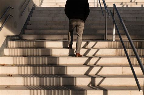 Premium Photo Rear View Of Adult Man Walking Upstairs With Sunlight