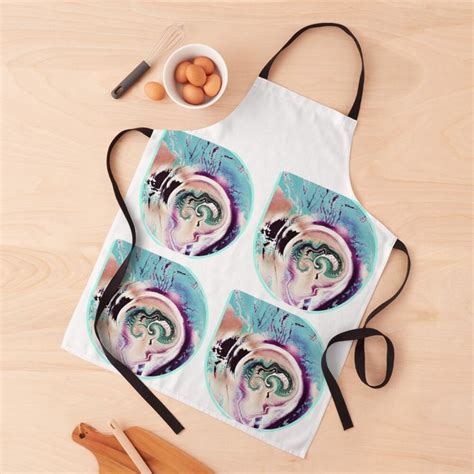 The Apron Has Four Pictures Of A Woman S Face On It And Is Next To Eggs