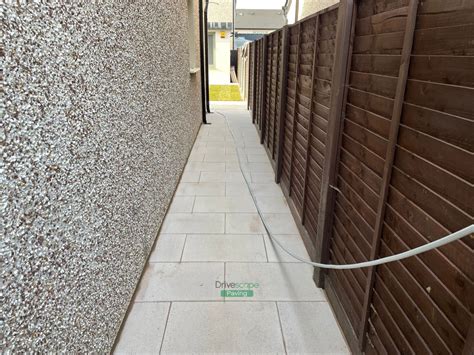 Patio With Quartz Slabs Rustic Slane Border And Roll On Turf In