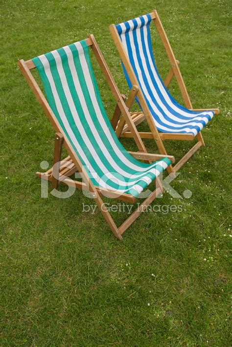 Two Striped Deck Chairs On Green Grass Stock Photo | Royalty-Free ...