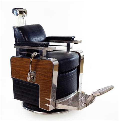 An Old Fashioned Barber Chair With Wood And Metal Trimmings On The Back