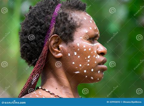 The Woman Of A Papuan Tribe In Traditional Clothes And Coloring