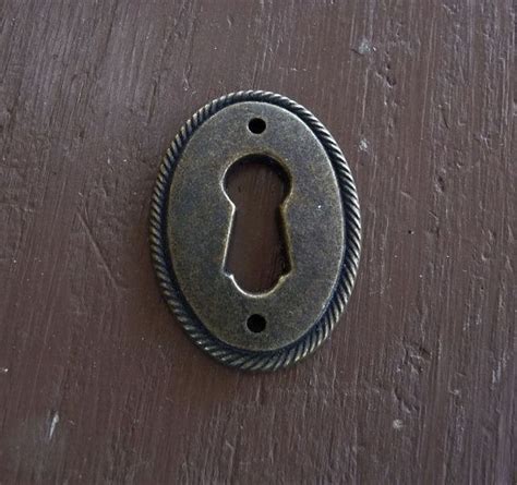 An Old Metal Keyhole On A Wooden Door