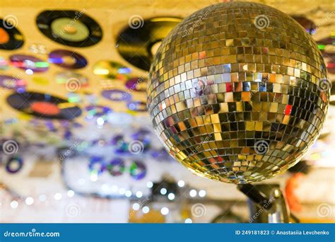 Mirror Disco Ball With Light Reflection Hanging On Ceiling In Nightclub