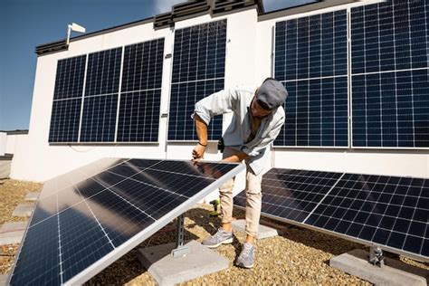 Premium Photo Man Installing Solar Panels On The Roof Of His House