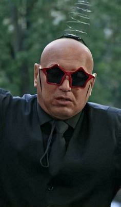 A Bald Man Wearing Red Sunglasses And Black Shirt