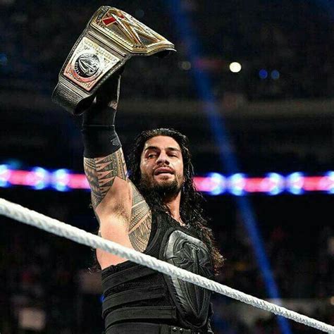 Roman Reigns Holding Up Wwe World Heavyweight Champion Belt Roman