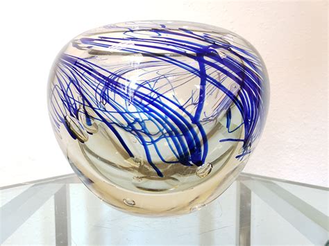 A Blue And White Vase Sitting On Top Of A Glass Table