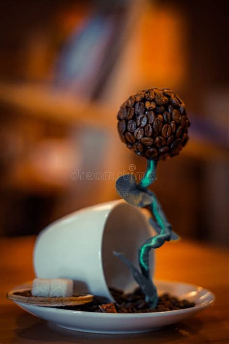 A Sculpture of Coffee Bean Drinking a Cup of Coffee. Editorial ...