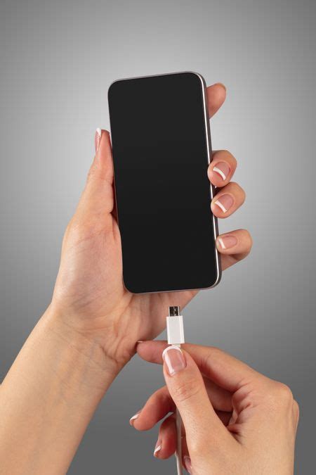 Close Up View Of Hand Charging Smartphone Freestock Photos