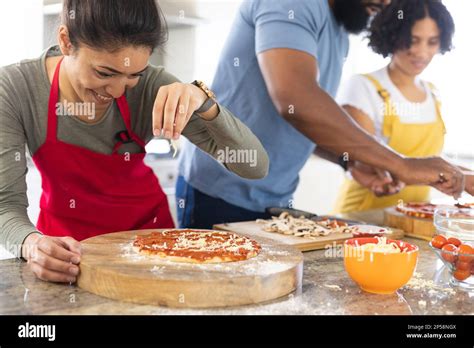 Happy Diverse Friends Cooking Together In Kitchen Stock Photo Alamy