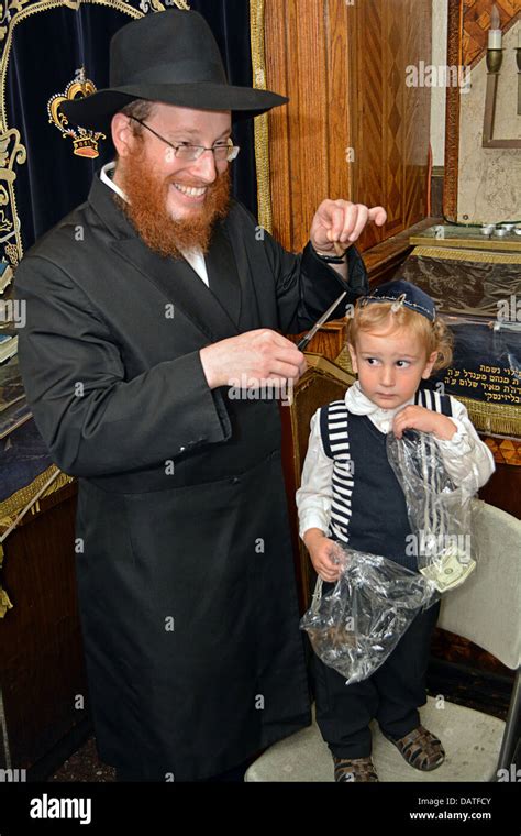 A 3 year old religious Jewish boy getting his first haircut - a lock ...