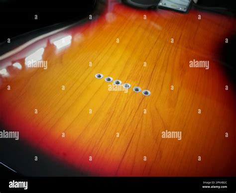 Close Up Shot Of Holes For String In Eletronic Back Side Of Guitar Body