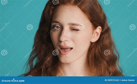 Portrait Of Attractive Flirty Girl Winking On Camera Over Colorful