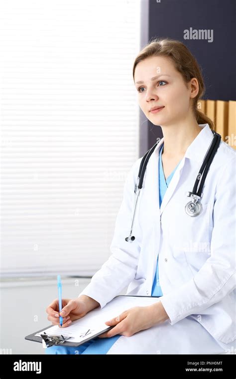 Woman Doctor At Work At Hospital Young Female Physician Write