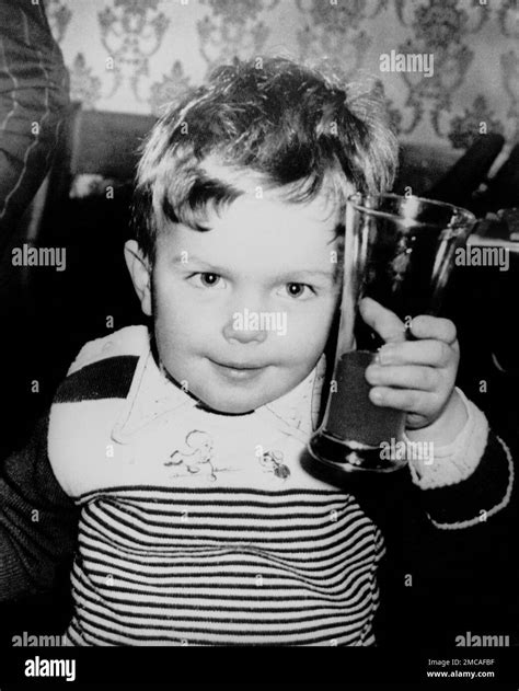 Three Year Old Ruari Lifts A Glass Of Lemonade After Attending The