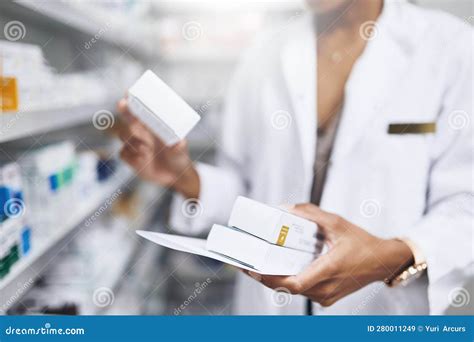 Get Your Prescriptions Filled Here A Pharmacist Filling A Prescription At A Chemist Stock