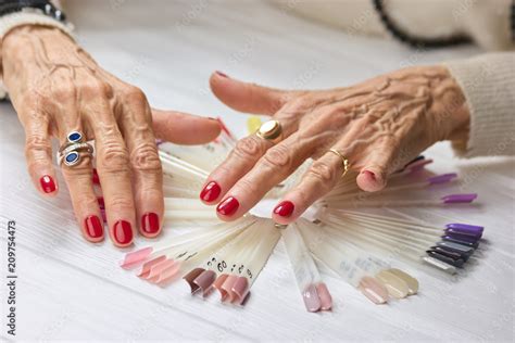 Wrinkled Woman Hands With Red Manicure Hands Of An Old Woman With