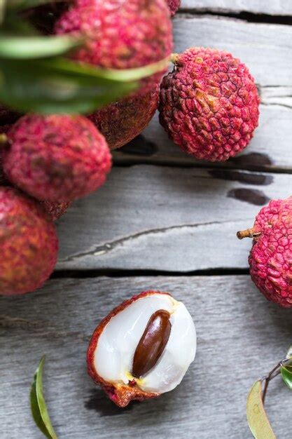 Premium Photo Fresh Bunch Of Lychees On Wooden Table