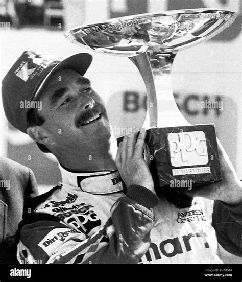 Britains Nigel Mansell Holds The Trophy For Winning The Indy Car World