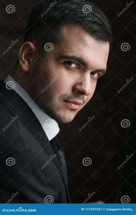 Portrait Of A Man In A Black Jacket Turned Into Darkness Stock Image