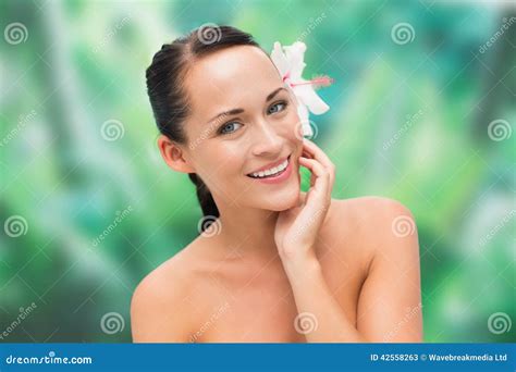 Beautiful Nude Brunette Smiling At Camera With Flower In Her Hair Stock