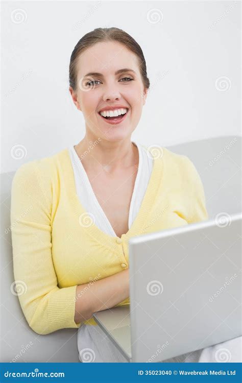 Cheerful Casual Woman With Laptop Sitting At Home Stock Photo Image