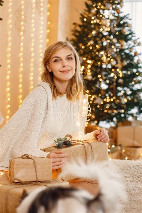 Portrait Of A Blonde Woman Sitting Near Christmas Tree Stock Photo Image Of Luxury Cosmetic