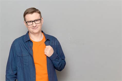 Portrait Of Happy Mature Man With Glasses Wearing Casual Blue Shirt
