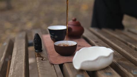 pouring tea from a glass cup into tea bowls. outdoors tea ceremony 28585136 Stock Video at Vecteezy