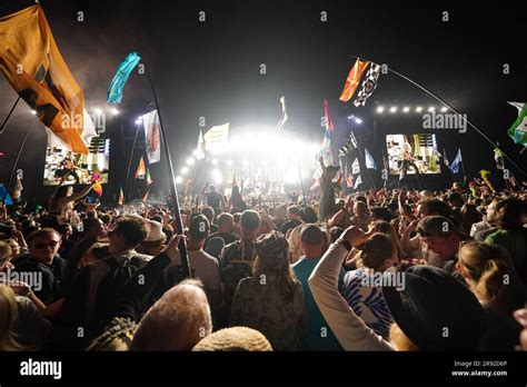 Crowds Watch The Arctic Monkeys Performing At The Glastonbury Festival