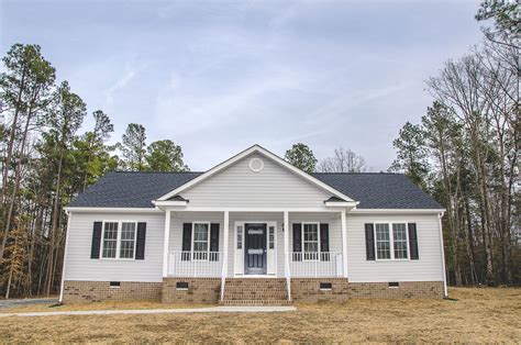 Brand new rancher with 'A' roof over the front porch and gray vinyl siding. We love the black ...