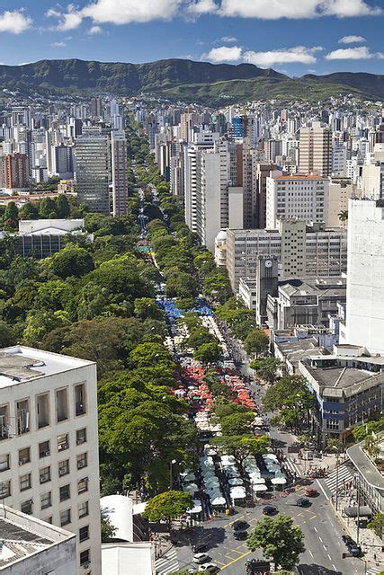 An Aerial View Of A City With Tall Buildings And Trees In The