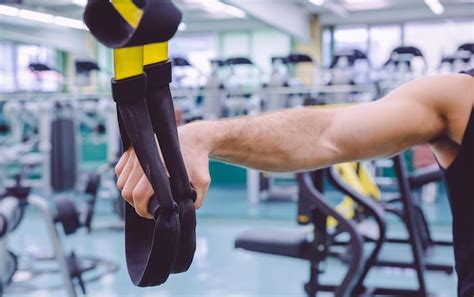 Premium Photo Cropped Image Of Man Holding Ropes At Gym